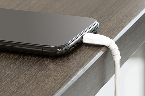 USB to Lightning cable charging an iPhone