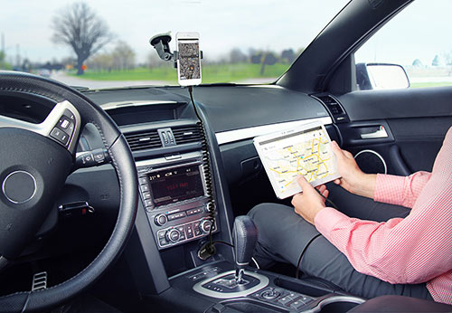 Charging an iPhone in a car phone mount while charging the passenger’s Samsung tablet