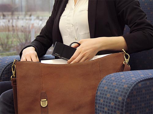 Photo showing the multiport adapter tucking neatly into a laptop travel bag for easy portability